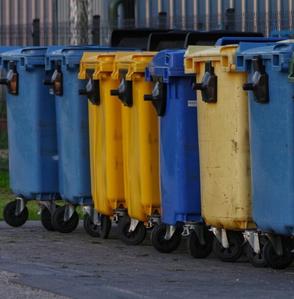 a row of blue and yellow trash cans